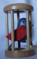 Papoušek v kleci modré tělo červená křídla